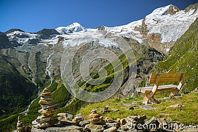 Just to sit and relax looking at majestic Fee Glacier located above Saas-Fee village Stock Photo