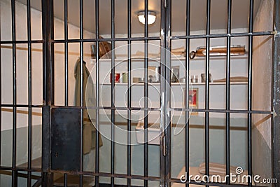 Prison cell with jail iron bars for criminals Stock Photo