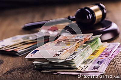 Justice and euro money. Euro currency. Court gavel and rolled Euro banknotes. Representation of corruption and bribery in the judi Stock Photo