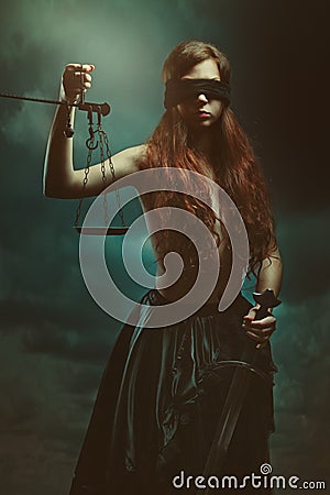 Justice goddess and dark cloudscape Stock Photo