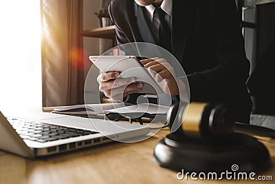 Male lawyer in the office with brass scale on wooden table. justice and law concept in morning light Stock Photo