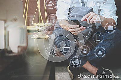 Justice and Law context.Male lawyer hand sitting on sofa and working with smart phone,digital tablet computer docking keyboard wi Stock Photo