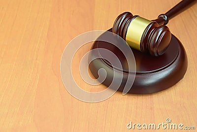 Justice mallet on wooden desk in a courtroom during a judicial trial. Law concept and empty space for text. Judge hammer Stock Photo