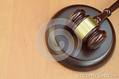 Justice mallet on wooden desk in a courtroom during a judicial trial. Law concept and empty space for text. Judge hammer Stock Photo