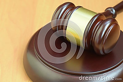 Justice mallet on wooden desk in a courtroom during a judicial trial. Law concept and empty space for text. Judge hammer Stock Photo