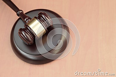 Justice mallet on wooden desk in a courtroom during a judicial trial. Law concept and empty space for text. Judge hammer Stock Photo