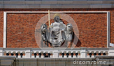 Justice between the Venetian lions on the facade of the tower of St Mark`s bell tower, Venice Stock Photo