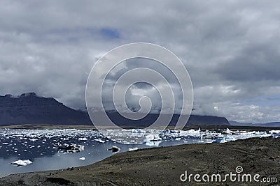 JÃ¶kulsÃ¡rlÃ³n glacier lagoon in dramatic light, Iceland Stock Photo