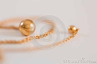 18K golden ball necklace on white closeup Stock Photo