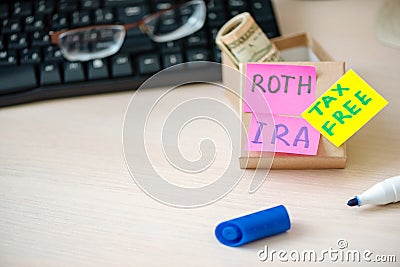 401k ira roth on pieces of colorful paper dollars on table. Pension concept. Retirement plans Stock Photo