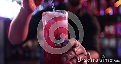 Professional male bartender pouring mixed blue liquor cocktail drink Stock Photo