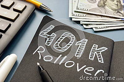 401k rollover memo on the notepad and cash. Stock Photo