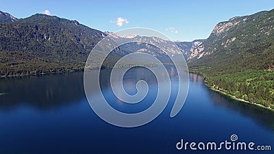 4K Vol et décollage élevés au-dessus de stupéfier le lac Bohinj pendant le matin Eau profonde et montagnes bleues de Julian Alps banque de vidéos 4K Vol et décollage élevés au-dessus de stupéfier le lac Bohinj pendant le matin Eau profonde et montagnes bleues de Julian Alps banque de vidéos