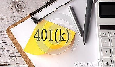 401k word on a yellow sticky with calculator, pen and clipboard Stock Photo