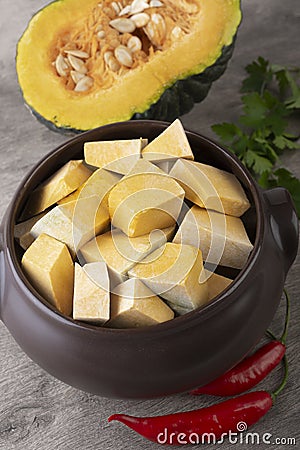 Kabocha pieces on a bowl with half fruit Stock Photo