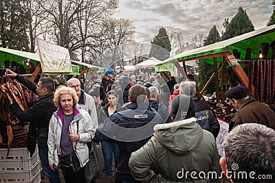 KACAREVO, SERBIA - FEBRUARY 18, 2023: Crowd of people in a packed alley of the Kobasicijada, a traditional market of cured meat Editorial Stock Photo
