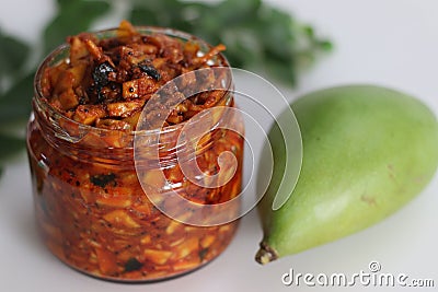 Kadumanga achar. Kerala style instant mango pickle made of chopped unripe raw totapuri mangoes, with mustard leaves, curry leaves Stock Photo