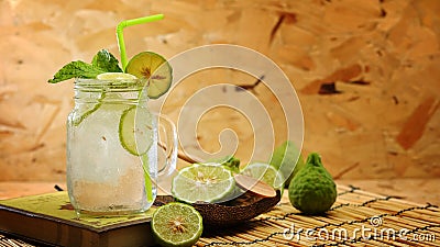 Kaffir lime So, Bergamot soda Cool drink, Thailand tradition Herb for Treatment of Acid Reflux, with Oriental Earth tone map backg Stock Photo