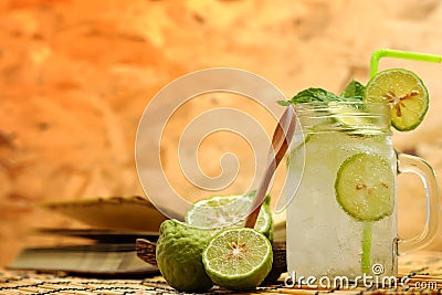 Kaffir lime So, Bergamot soda Cool drink, Thailand tradition Herb for Treatment of Acid Reflux, with Oriental Earth tone map backg Stock Photo