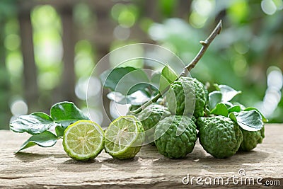 Kaffir lime with leaves on wooden background. Stock Photo