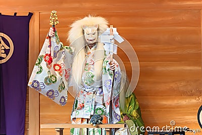 Kagura dance performed by the Inari fox deity holding suzu bells and a gohei wand. Stock Photo