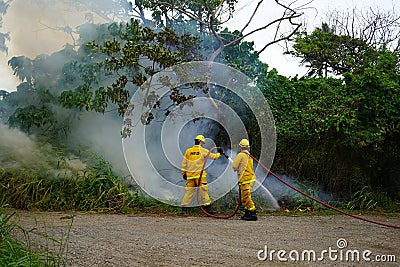 Kahuku, HI - Jan 3, 2024: Honolulu Fire Department HFD firefighters responding to wild brush fire in Oahu. Editorial Stock Photo