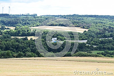 Kaisersesch, Germany - 07 26 2022: The Autobahn with passing trucks and wind power plants Stock Photo