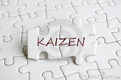 Kaizen text on jigsaw puzzle that represent change for the better by small, steady, cumulative gains. Continuous improvement Stock Photo