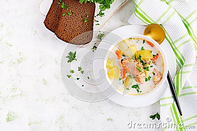 Creamy soup with salmon, potatoes, onions and carrots and in a bowl. Stock Photo