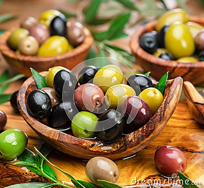 Kalamata, green and black olives in the wooden plates. Food background Stock Photo