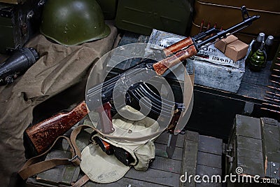 Kalashnikov AK 47 with ammunitions on army box background Stock Photo