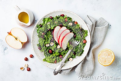 Kale salad with dried cranberry, hazelnuts and sliced apple. Stock Photo