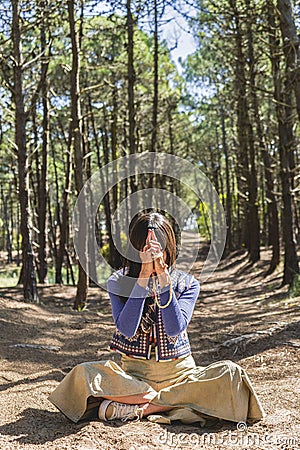 Kali mudra executed in lotus position by a woman in a forest Stock Photo