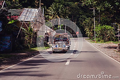 A modified bus on a road in Kalibo Editorial Stock Photo