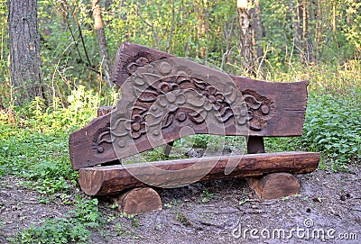 KALININGRAD REGION, RUSSIA. Wooden decorative carved bench on the territory of the Visitor Center `Museum Complex of the Curonian Editorial Stock Photo