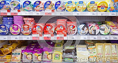 Processed cheese on shelves of supermarket Editorial Stock Photo