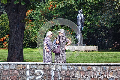 KALININGRAD, RUSSIA - AUGUST 22, 2019: Unknown elderly women have a conversation in the city park on a sunny day Editorial Stock Photo