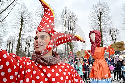 KALININGRAD, RUSSIA. The buffoon`s portrait against the background of Maslenitsa effigy in the park Editorial Stock Photo