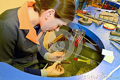 KALININGRAD, RUSSIA. Female jeweller measures blanks for rings Editorial Stock Photo