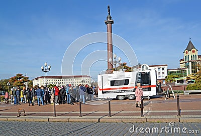 KALININGRAD, RUSSIA. Queue of people for vaccination at a medical mobile station. The epidemic of coronavirus COVID-19. Victory Sq Editorial Stock Photo