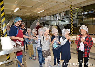 KALININGRAD, RUSSIA. Chocolate mass tasting in production. Children `s tour to the Belgostar chocolate factory Editorial Stock Photo