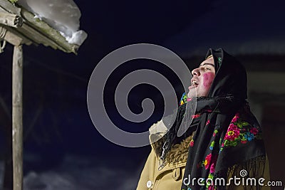 Kalyada ceremony. Slavic folk festival on the eve of the old new year.Man in ethnic costume is going to carol Editorial Stock Photo