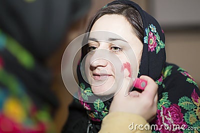 Kalyada ceremony. Slavic folk festival on the eve of the old new year.Woman in Russian scarf about to carol Editorial Stock Photo