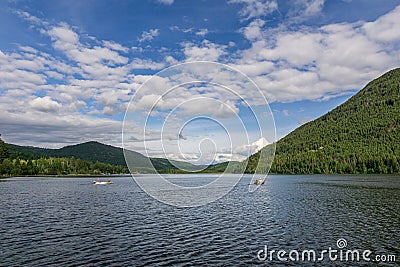 KAMLOOPS, CANADA - JULY 8, 2020: people in the boat Paul Lake Provincial Park with blue sky and white clouds Editorial Stock Photo