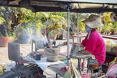 Kampot, Cambodia - 12 April 2018: khmer woman cooking meat kebab on street kitchen. Cambodian streetfood eatery Editorial Stock Photo