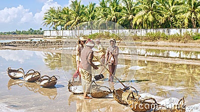 Cambodian women working in a salt field on a hot sunny day. Editorial Stock Photo