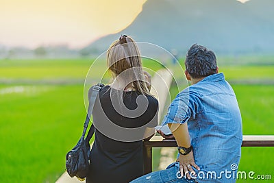 KANCHANABURI THAILAND - April 10 : Unidentified couple sit for resting and waiting for time to take photos of the sunset on April Editorial Stock Photo