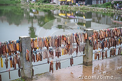 Prayer tags tied on the bridge in the Pilok mine village in kanchanaburi City Thailand. Editorial Stock Photo