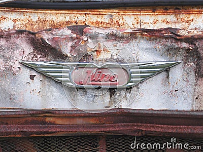 Logo of the Hino Motor`s Ltd. brand on a the front of the rusty truck background Editorial Stock Photo