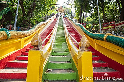 Kanchanaburi, Thailand-October 23, 2022 : Tourists are walking up and down the brightly colored stairs at Wat Tham Seua Editorial Stock Photo